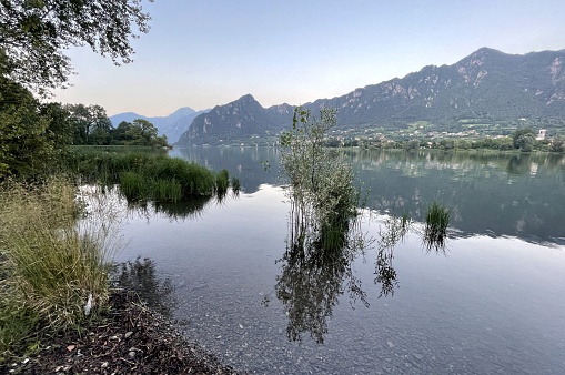 lake idro in italy between mountains and water in summer