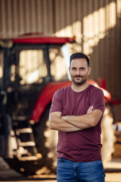 istock Adult man, using a tractor to plant the vegetables. 1335261917