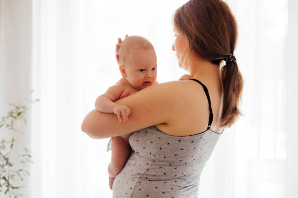 istock Mother And Daughter Standing Against Wall 1335263574