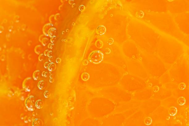 istock Orange slice and ice cubes with bubbles in cold carbonated drink. 1335264895