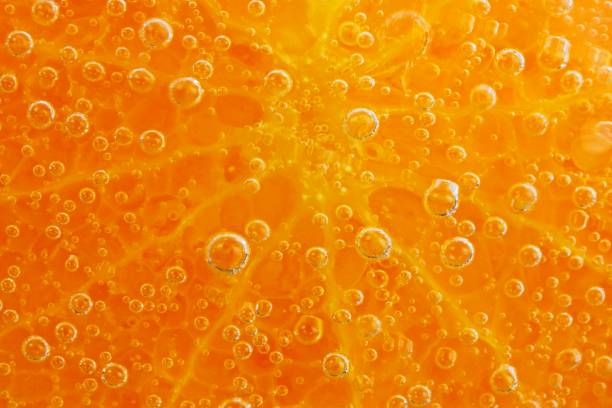 istock Orange slice and ice cubes with bubbles in cold carbonated drink. 1335264932