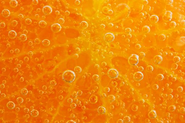 Orange slice and ice cubes with bubbles in cold carbonated drink. Lemon slice and ice cubes with bubbles in cold carbonated drink. carbonate mineral stock pictures, royalty-free photos & images