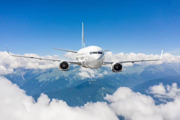 istock Airplane flies over clouds and mountain ranges. 1335267619