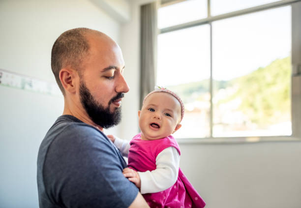 istock Father with cute daughter at home 1335267859