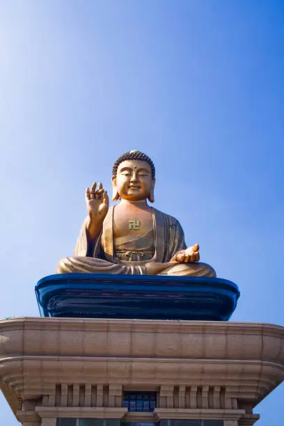 Photo of the giant Buddha statue with the blue sky background