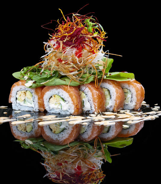 istock Philadelphia roll with salmon and lettuce on glossy black background 1335273155