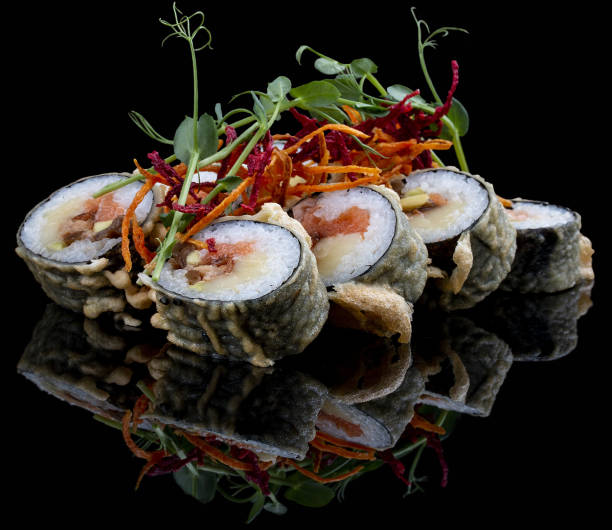 istock Tempura roll with salmon and tuna on glossy black background. Deep fried. 1335273676