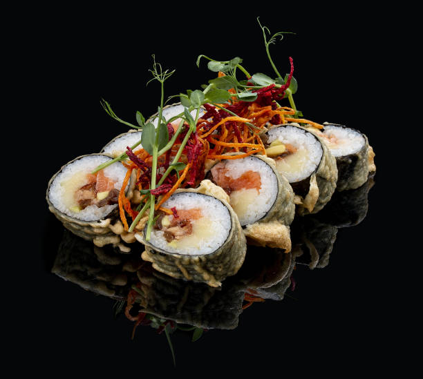 istock Tempura roll with salmon and tuna on glossy black background. Deep fried. 1335274239