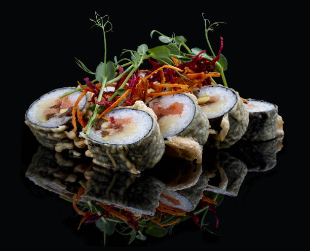 istock Tempura roll with salmon and tuna on glossy black background. Deep fried. 1335274250