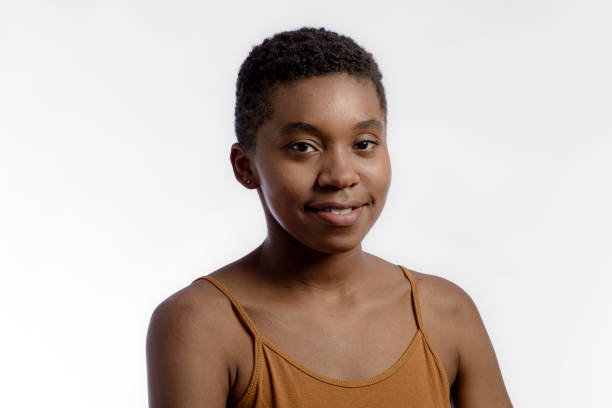 istock Young woman looking at camera in studio portrait. 1335276812