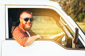 Bearded cheerful driver driving his camper van