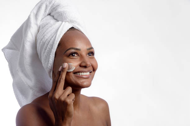 istock Model putting beauty product on her face after bath. 1335277871