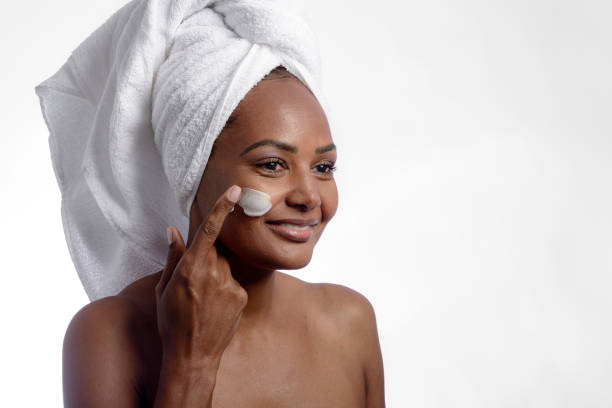 istock Model putting beauty product on her face after bath. 1335277945