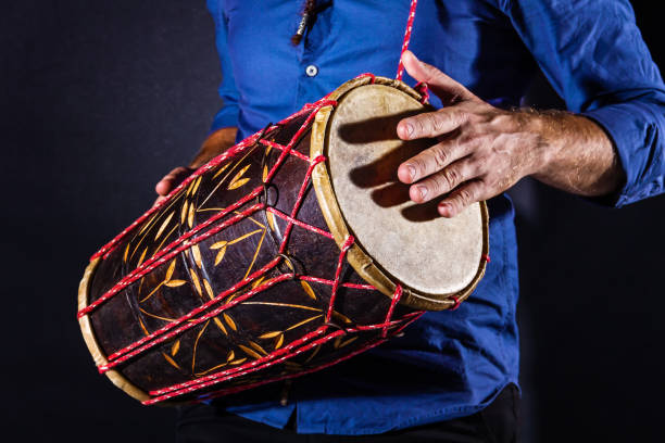 istock Man is drumming on wooden ethnic drum 1335277997