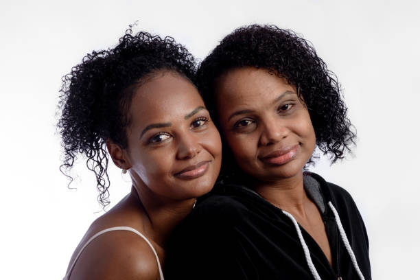 istock Sisters together in photo studio looking at camera 1335278492