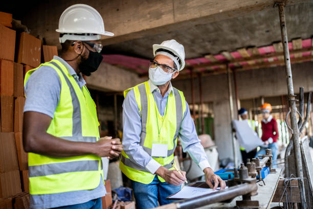 istock Engineer and contractor doing an informal meeting on construction site 1335283301