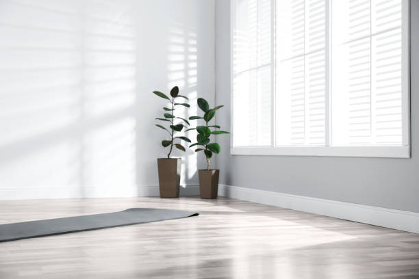 istock Unrolled grey yoga mat on floor in room 1335283510
