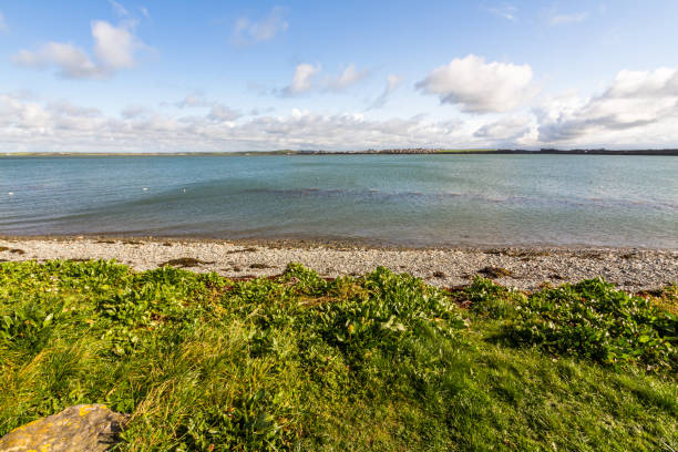 istock View over water to land on the other side. 1335283646