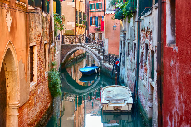 istock Canal with bridge and boats in Venice 1335283847