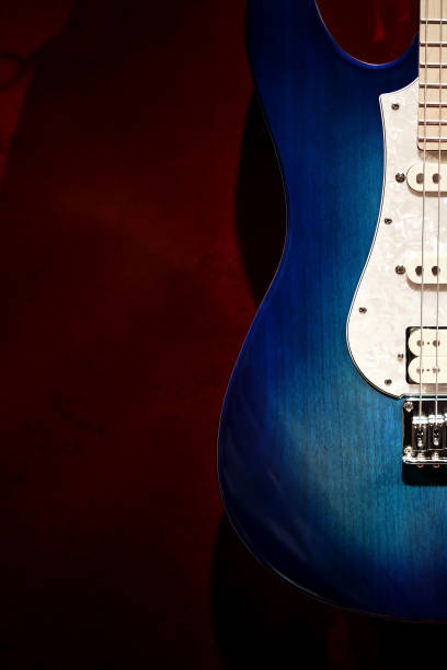 istock Blue and white electric guitar with red background 1335285707