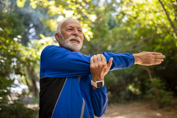 istock Senior man outstretching hands in park 1335285884
