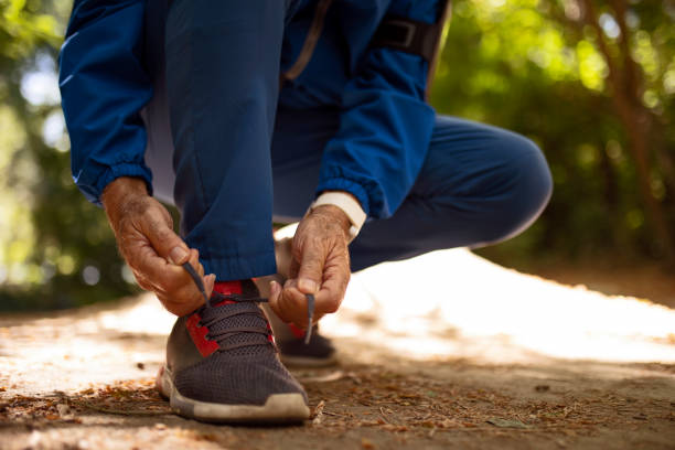 istock Senior man tying shoelace getting ready for workout 1335285895
