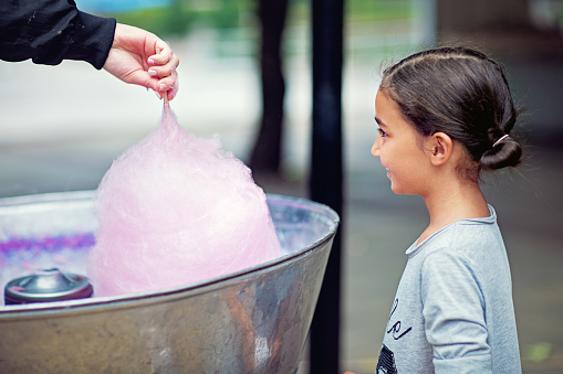 Portrait of little girl waiting for cotton candy