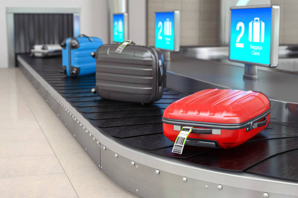 Baggage claim in airport terminal. Suitcases on the airport luggage conveyor belt. stock photo