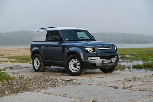 Japanese off-road used white car Toyota Hilux Surf on lake coast, car for fishing. Almaty, Kazakhstan - September 28, 2022