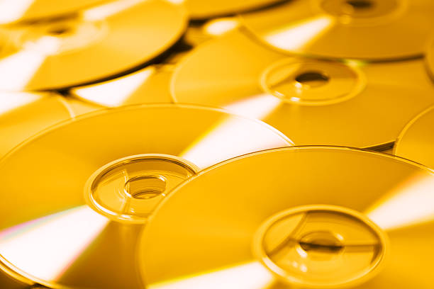 Small group of golden cd's . Selective focus. Toned image.