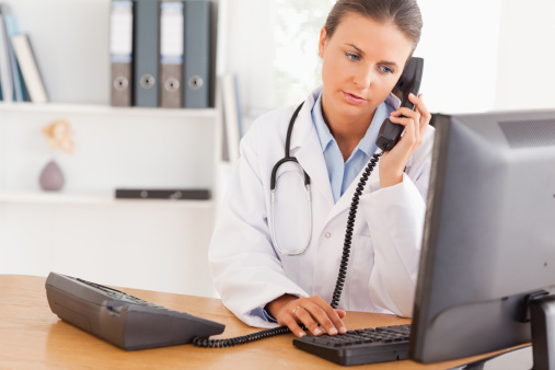 Serious doctor on the phone in her office