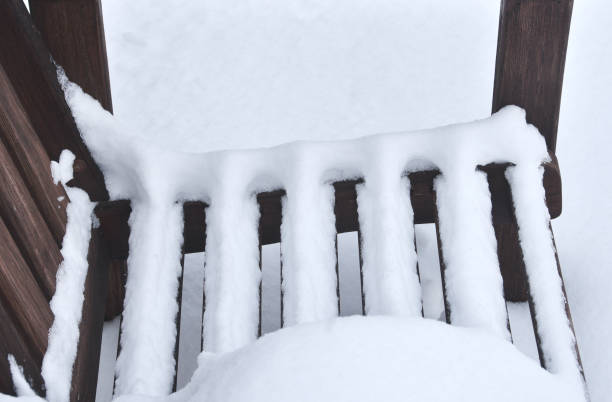 istock Snow on Wooden Bench 1335291330