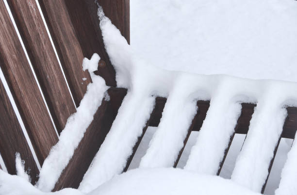 istock Snow on Wooden Bench 1335291534