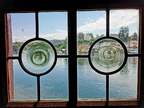 Old window with view to the river rhine. The image was captured during summer season.