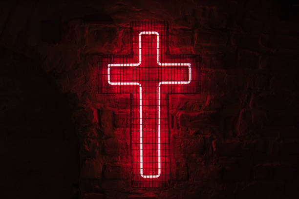 Glowing red neon cross hangs on the wall behind the bars. High quality photo