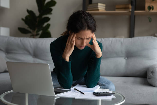 istock Close up stressed woman calculating bills, having problem with money 1335294919