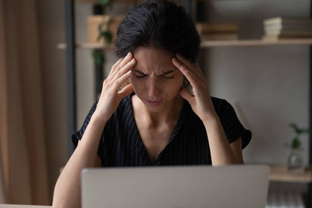 istock Close up tired stressed woman massaging temples, suffering from headache 1335294961