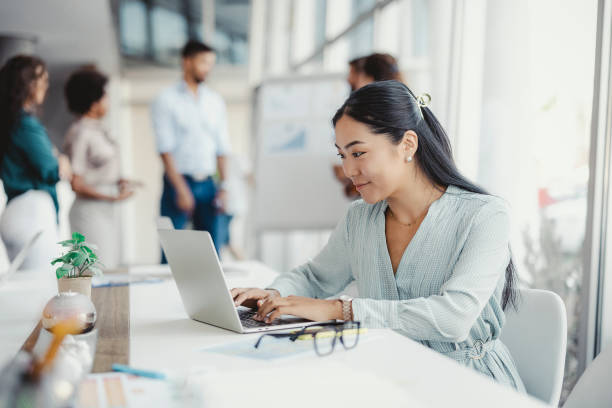 istock Asian Woman Working on Laptop 1335295797