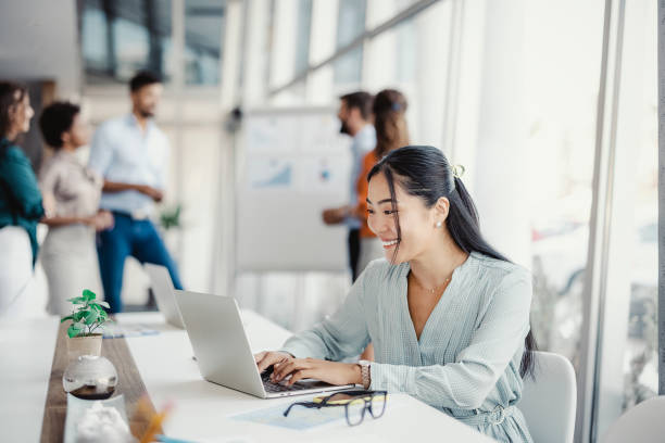 istock Asian Woman Working on Laptop 1335295801