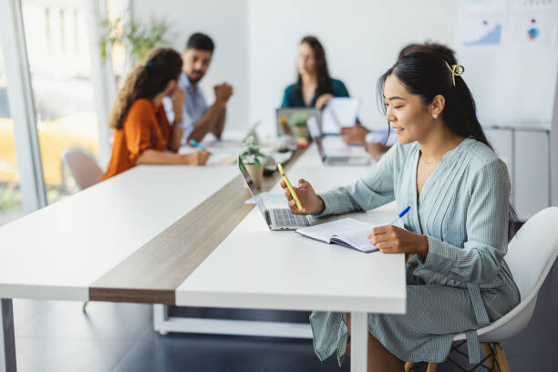 istock Businesswoman Working Against Colleagues 1335295830