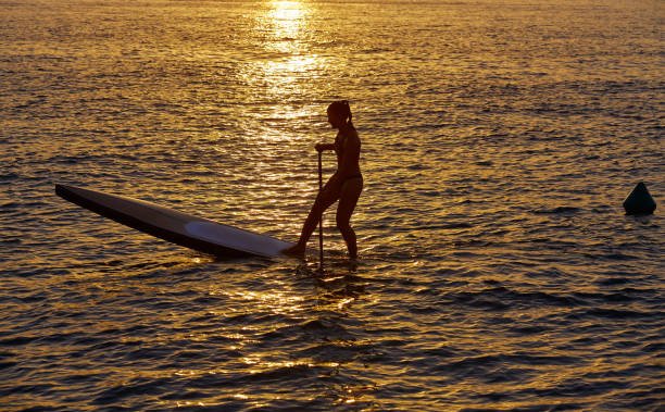 istock SUP Stand up Surf girl with paddle 1335299474