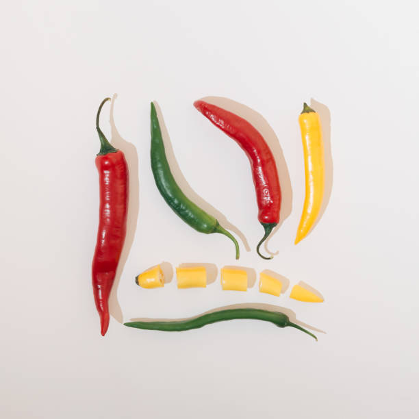 istock Hot peppers vegetables in several colors arranged in a square shape on a white background. Food concept 1335300948