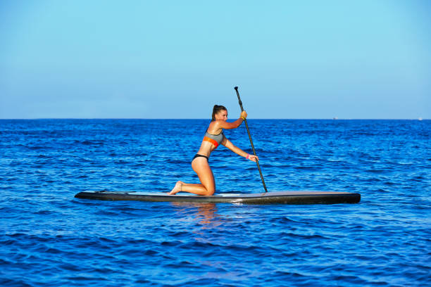 istock SUP Stand up Surf girl with paddle 1335301547