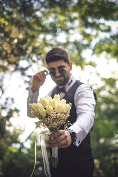 istock Groom holding a bridal bouquet 1335301599