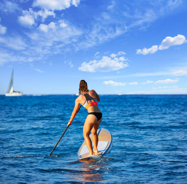 istock SUP Stand up Surf girl with paddle 1335301619