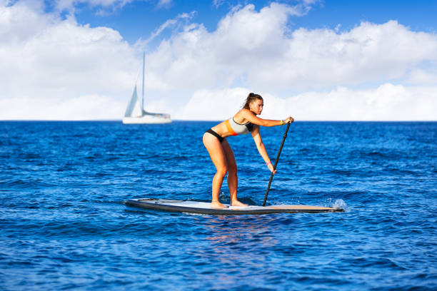 istock SUP Stand up Surf girl with paddle 1335301656