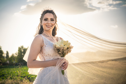 Portrait of beautiful bride holding bridal bouquet