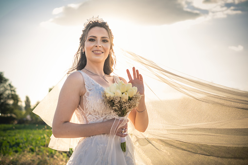 Portrait of beautiful bride holding bridal bouquet
