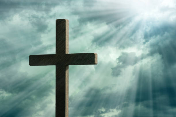 istock Religious cross against lightning and parting clouds 1335305110