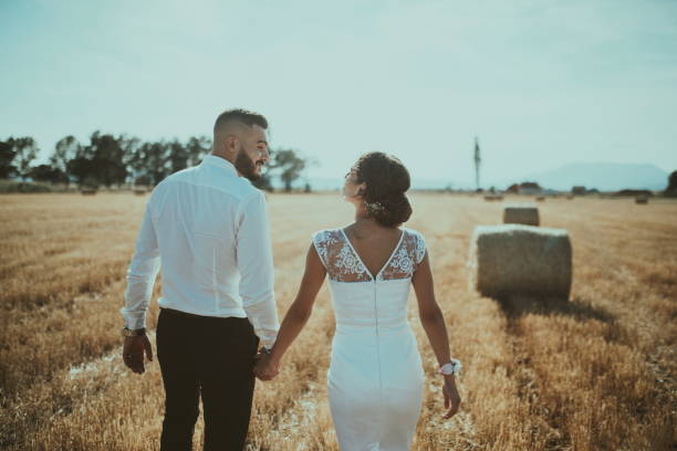 istock a young married couple in a large field enjoys the sunset. Selective focus 1335307447